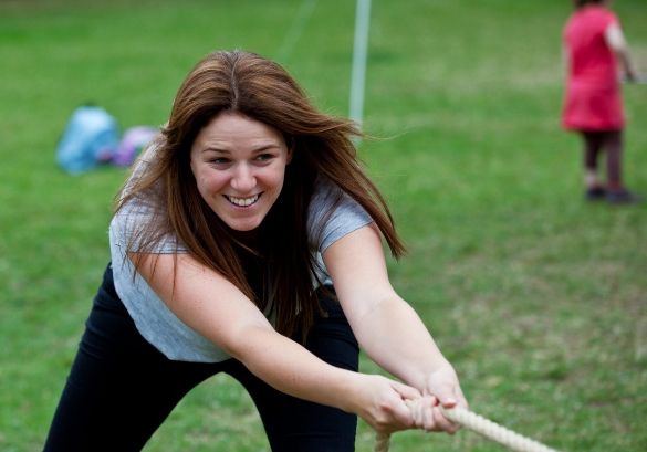 Woman playing tug of war at Airfield Estate