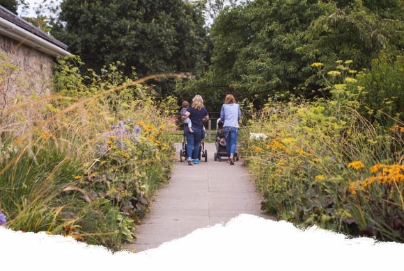 2 mums walking babies at Airfield Estate